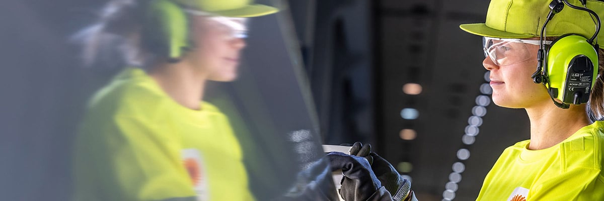 Mill worker in safety gear.