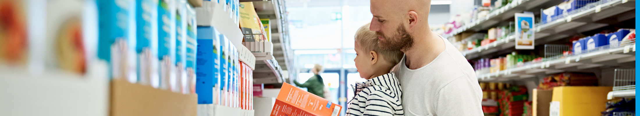 Father and son in shopping aisle