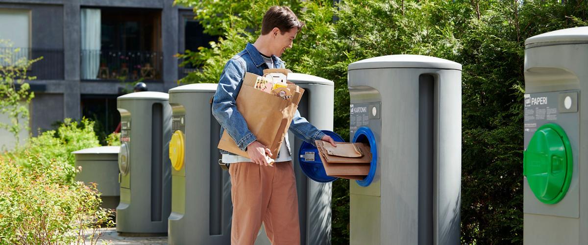 Young man recycling cartons