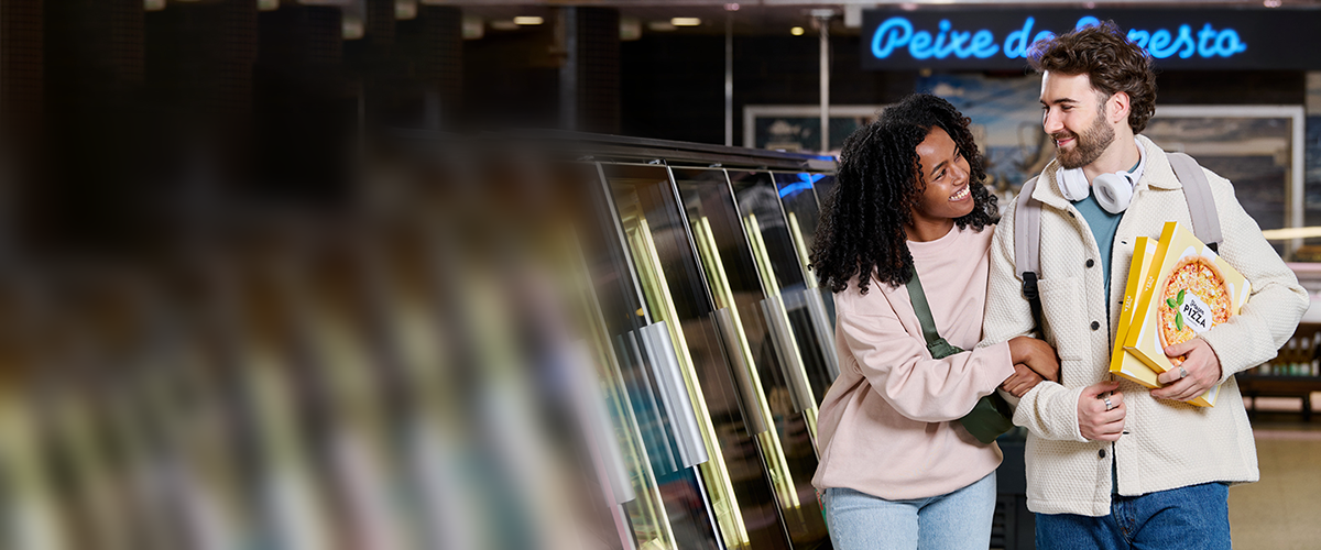 Couple with frozen food packaging in retail environment