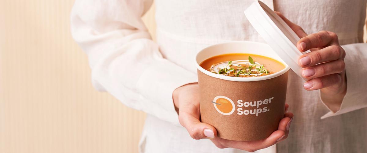 Woman holding hot soup cup